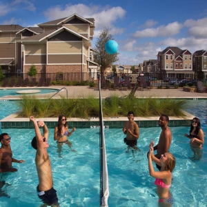 Group of students playing water volleyball